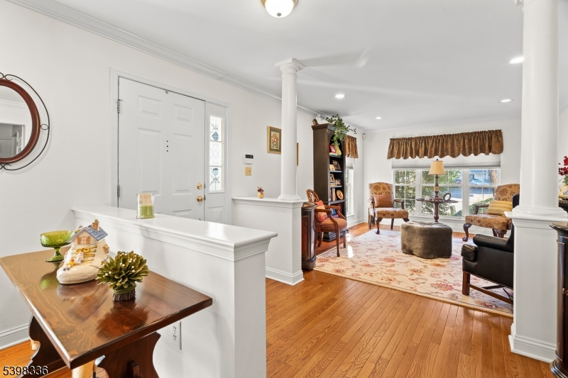 14 Minuteman Court Bernards, NJ 07920 - Photo 4 of 34 a living room with furniture a large window and kitchen view