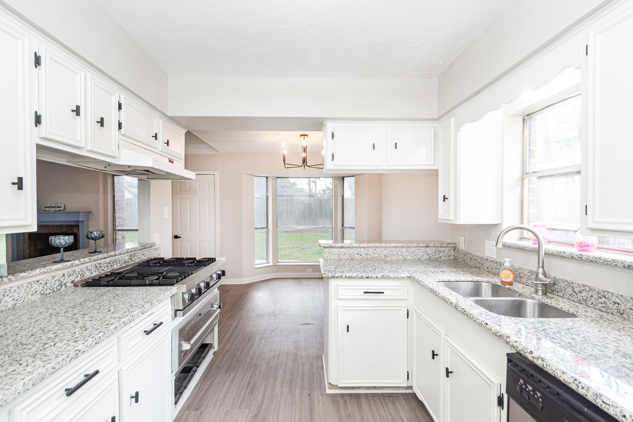 29019 Stapleford Street Spring, TX 77386 - Photo 10 of 27 a kitchen with granite countertop a sink stove and cabinets