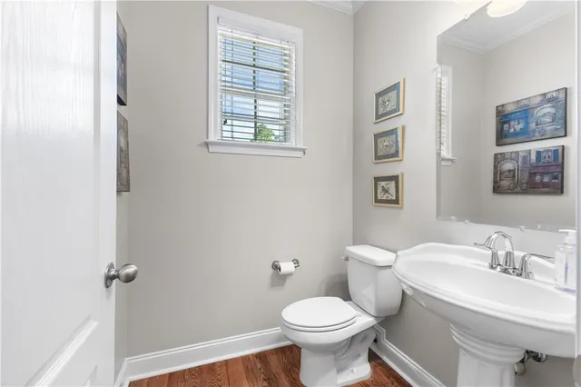 a bathroom with a sink toilet and a mirror