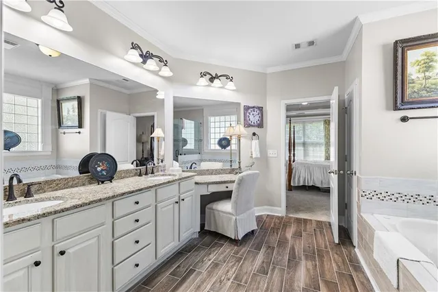 a spacious bathroom with a granite countertop sink mirror and shower