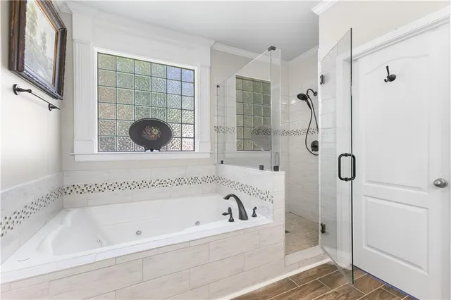 a bathroom with a tub and a shower