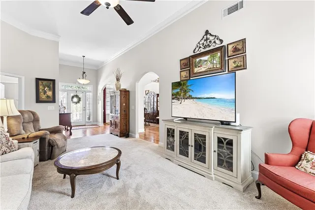 a living room with furniture a rug and kitchen view