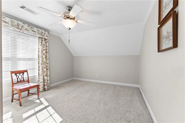 a view of a livingroom with a ceiling fan and window