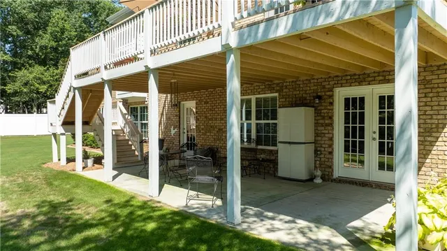 a view of a house with a yard and sitting area