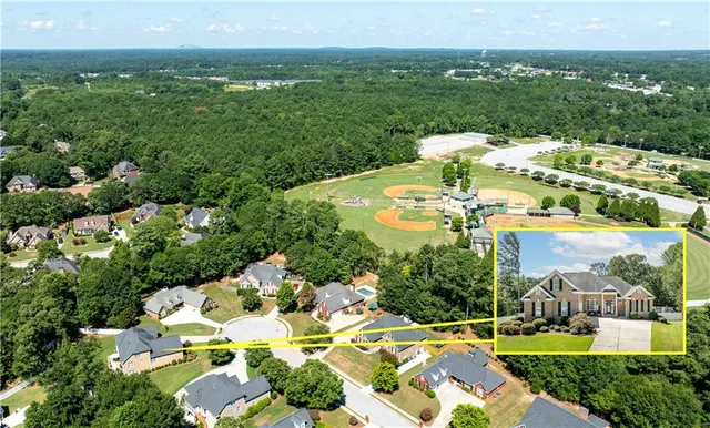an aerial view of residential house with outdoor space and swimming pool