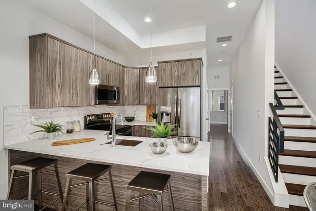 a kitchen with refrigerator and microwave
