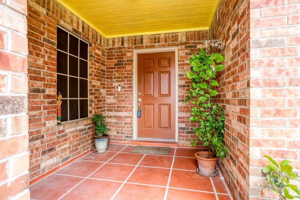 314 Hancock Odem, TX 78370 - Photo 2 of 40 a view of a door with a chair and a potted plant