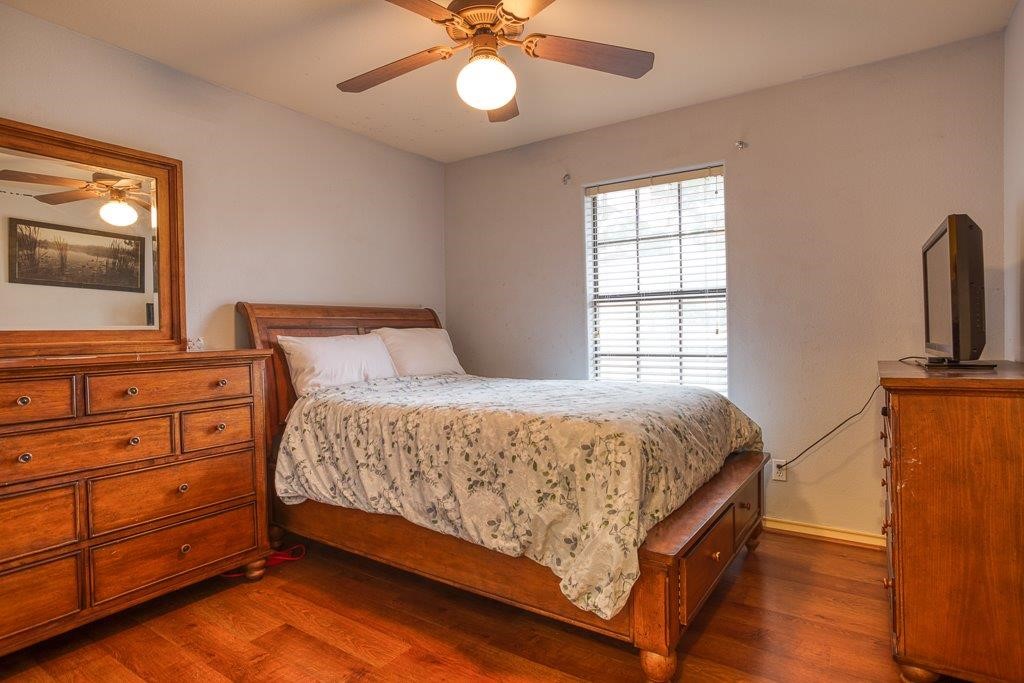 314 Hancock Odem, TX 78370 - Photo 21 of 40 a bedroom with a bed and a flat tv screen on dresser