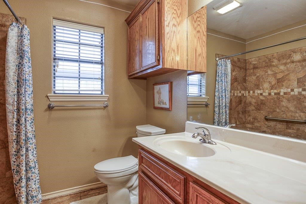 314 Hancock Odem, TX 78370 - Photo 26 of 40 a bathroom with a sink a toilet and a window