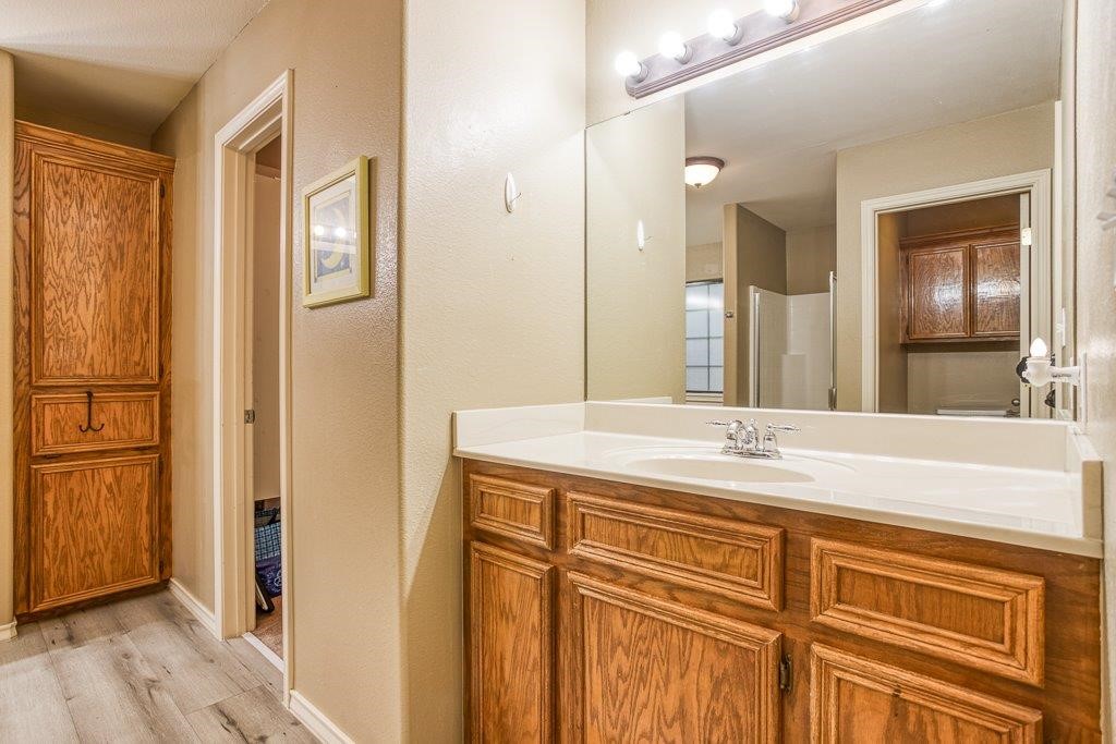 314 Hancock Odem, TX 78370 - Photo 28 of 40 a bathroom with a granite countertop sink a mirror and a shower