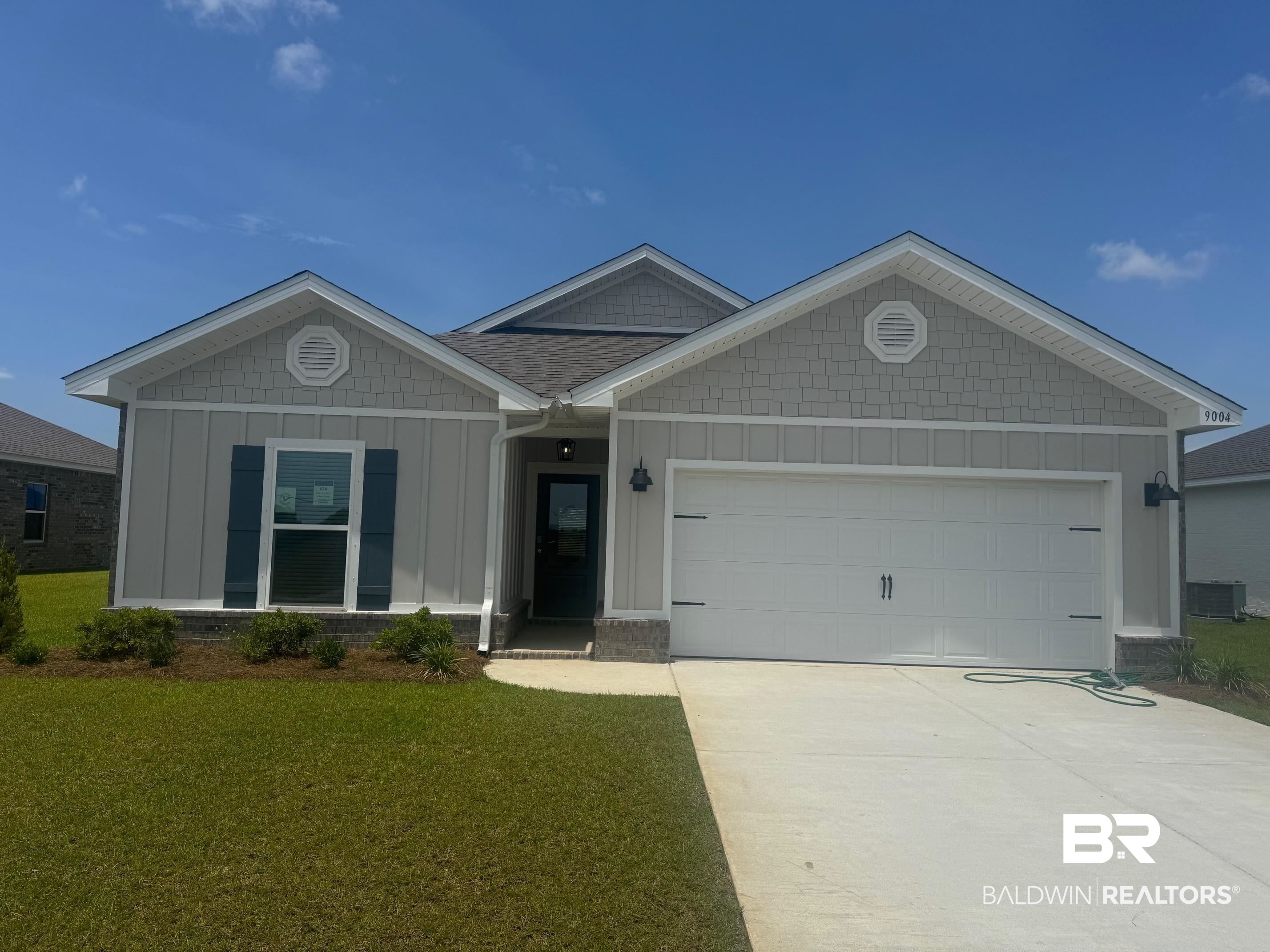 9004 Chabo Circle Foley, AL 36535 - Photo 1 of 33 View of front of house featuring board and batten siding, an attached garage, concrete driveway, a front yard, and central AC unit
