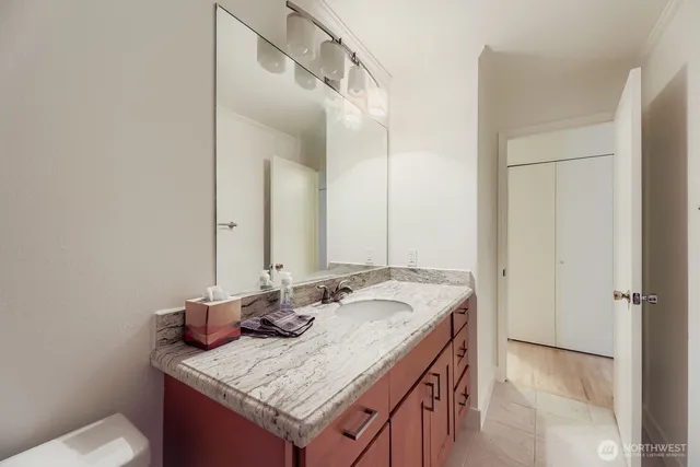 a bathroom with a granite countertop sink and a mirror