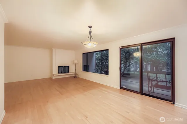 a view of an empty room with glass door