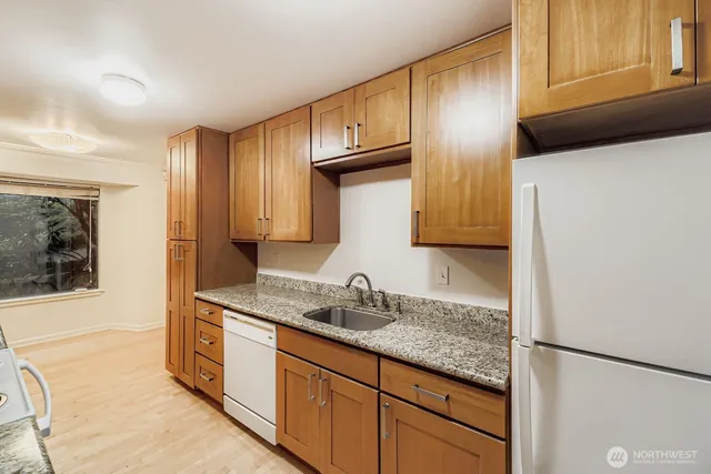 a kitchen with granite countertop stainless steel appliances and cabinets