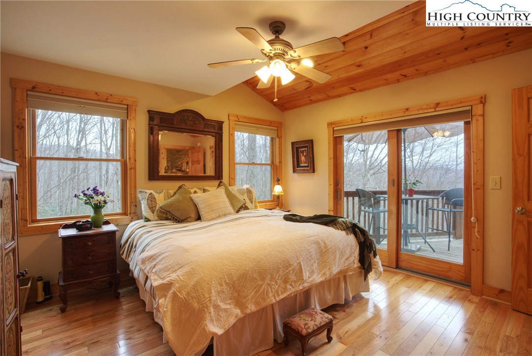 167 Rhododendron Drive Beech Mountain, NC 28604 - Photo 11 of 46 a bedroom with a large bed and a chandelier