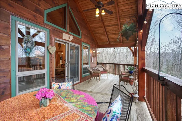 a bathroom with a sink a toilet a large mirror and shower curtain