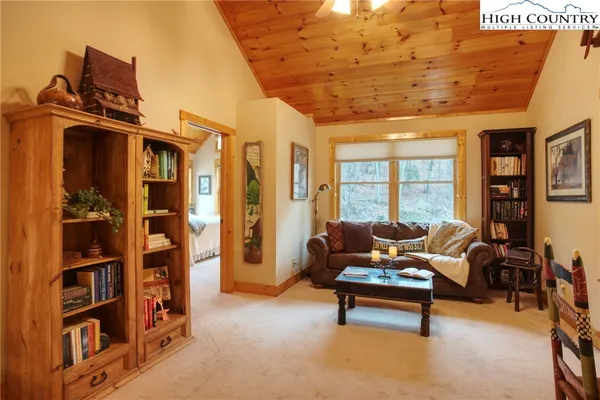 a living room with furniture gym equipment and a flat screen tv