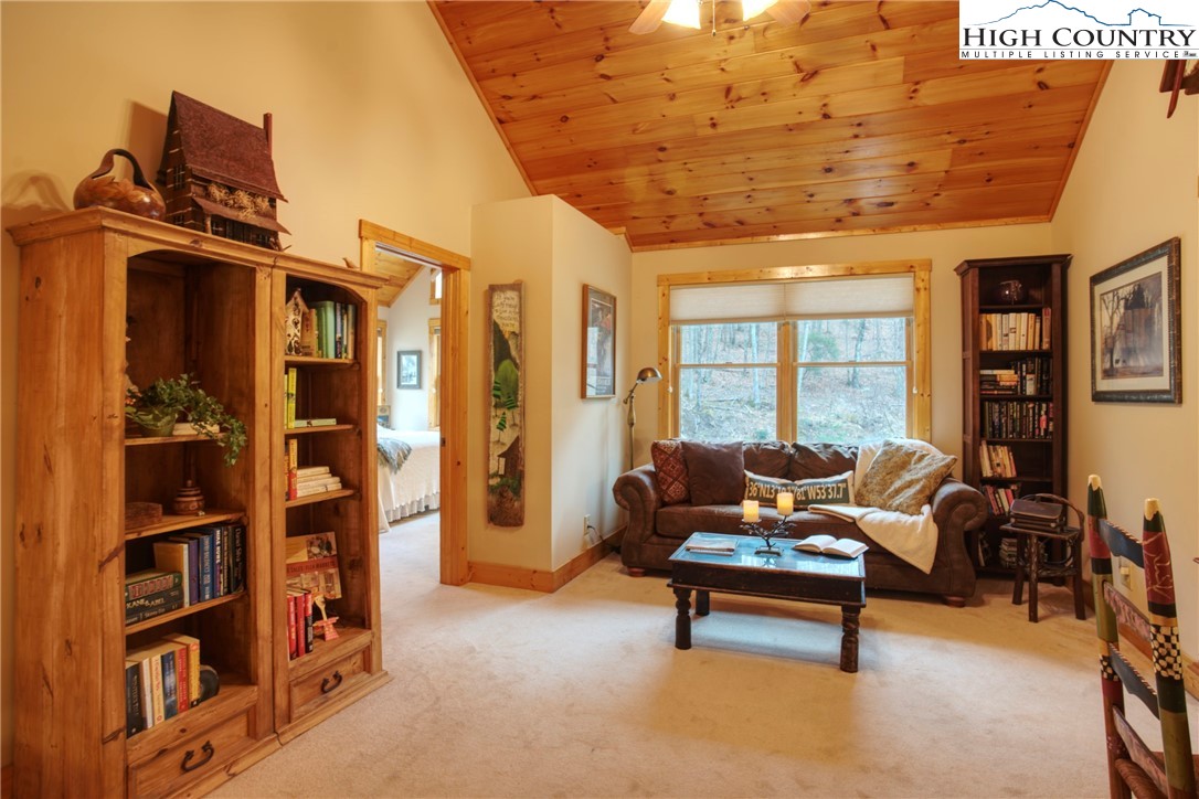 167 Rhododendron Drive Beech Mountain, NC 28604 - Photo 18 of 46 a living room with furniture a bookshelf and a large window