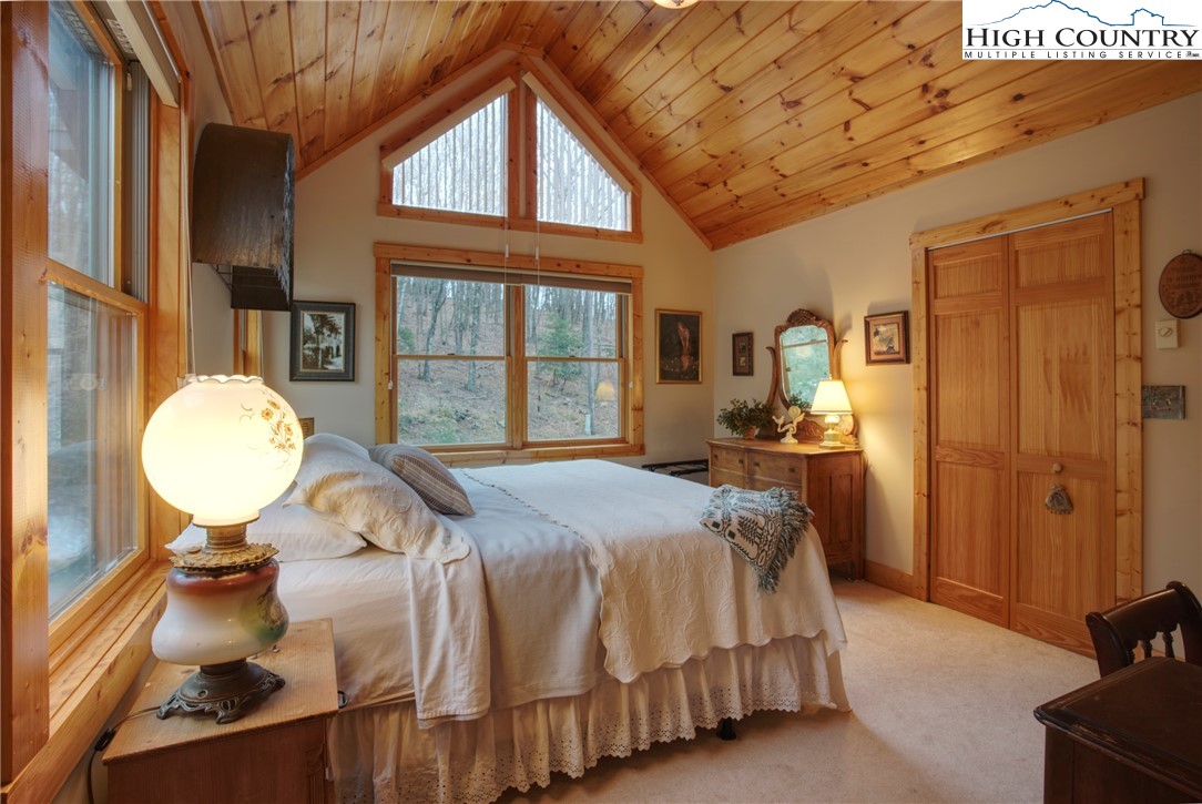 167 Rhododendron Drive Beech Mountain, NC 28604 - Photo 21 of 46 a bed room with a bed and a mirror