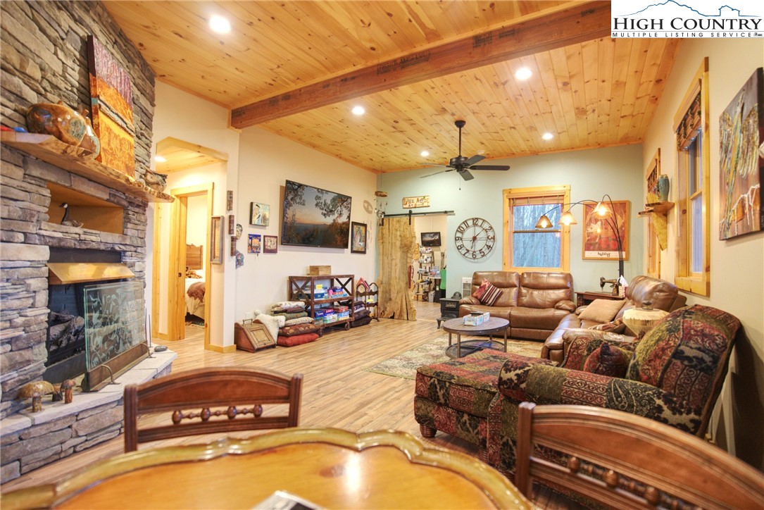 167 Rhododendron Drive Beech Mountain, NC 28604 - Photo 27 of 46 a living room with furniture gym equipment and a flat screen tv