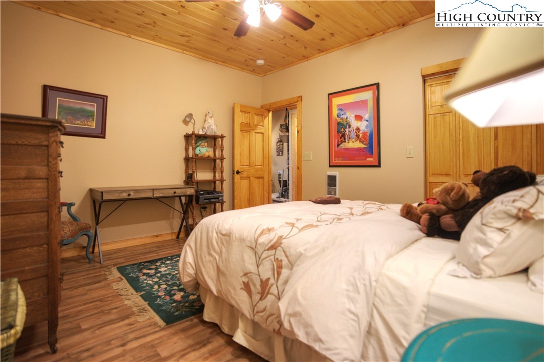 167 Rhododendron Drive Beech Mountain, NC 28604 - Photo 34 of 46 a bedroom with a bed and wooden floor
