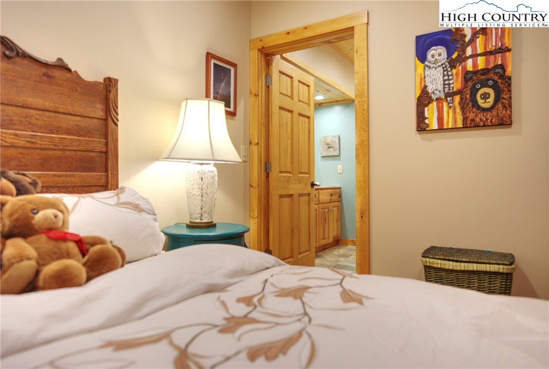 167 Rhododendron Drive Beech Mountain, NC 28604 - Photo 35 of 46 a bedroom with a bed and a window