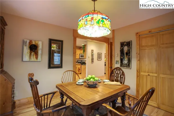 a view of a dining room with furniture and chandelier