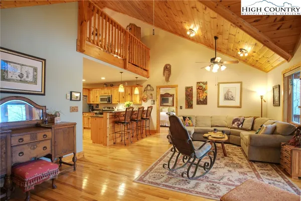 a living room with lots of furniture and a painting on the wall