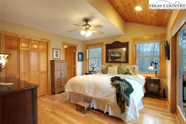 a bedroom with a large bed and a chandelier