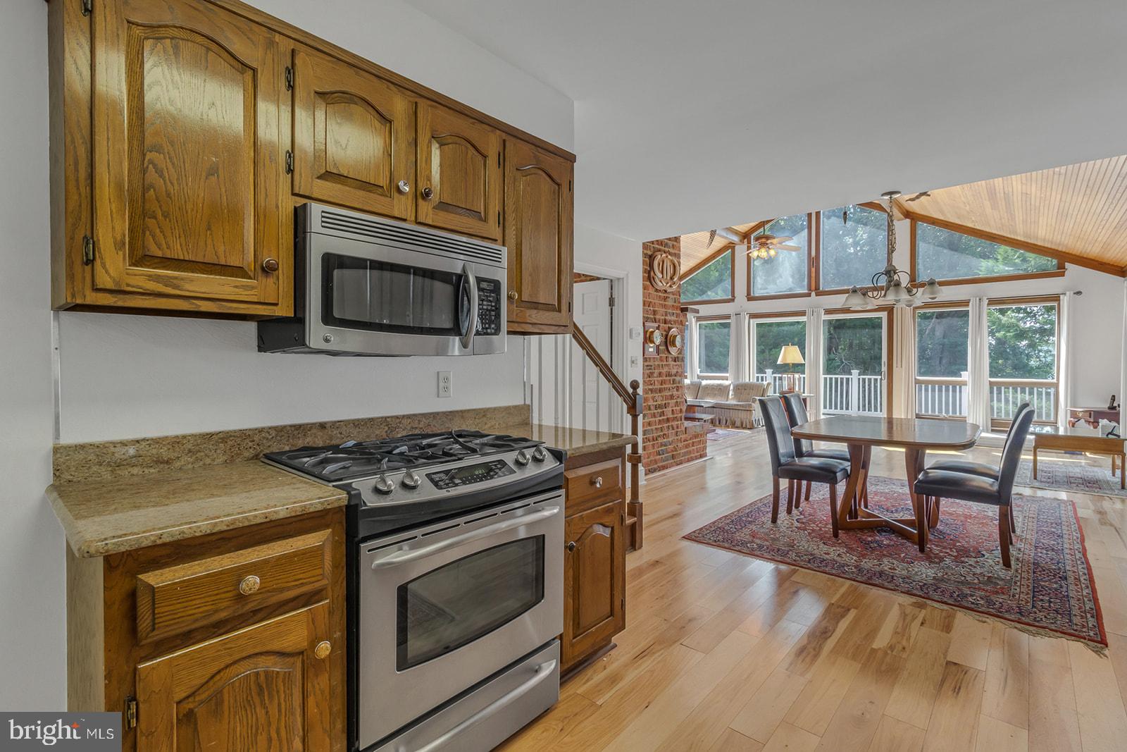 710 Train Lane Heathsville, VA 22473 - Photo 13 of 59 a kitchen with stainless steel appliances granite countertop a stove and a microwave