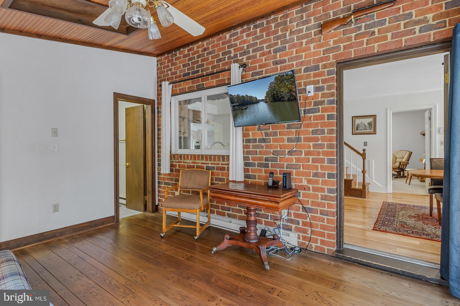 710 Train Lane Heathsville, VA 22473 - Photo 15 of 59 a view of a livingroom with wooden floor and a barbeque