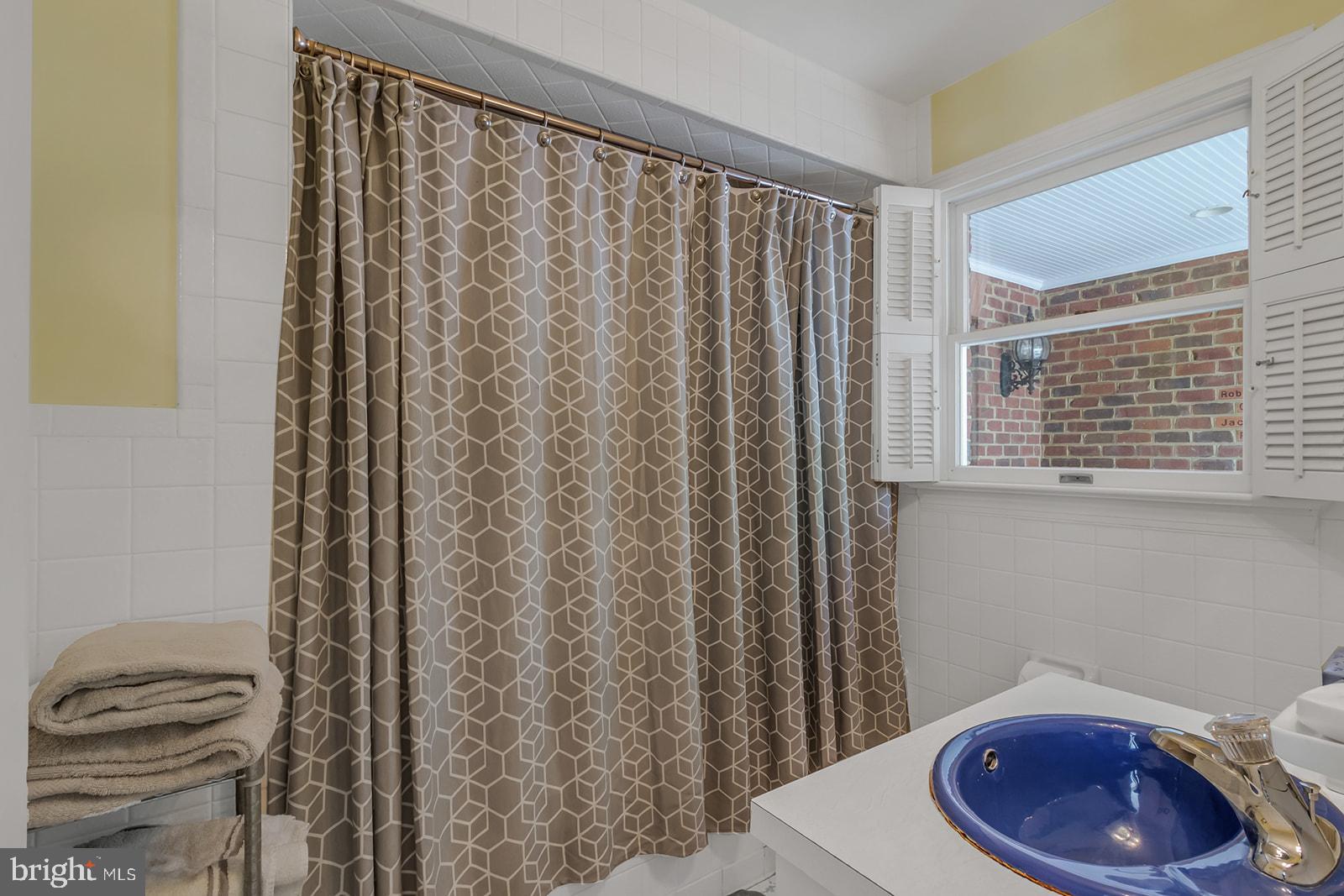 710 Train Lane Heathsville, VA 22473 - Photo 23 of 59 a bathroom with a toilet and a shower curtain