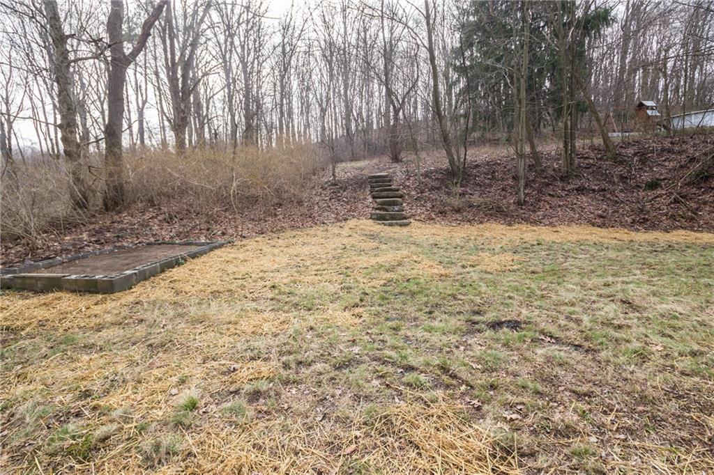 70 Simon Road Cheswick, PA 15024 - Photo 25 of 25 Level back yard with steps to wooded area.