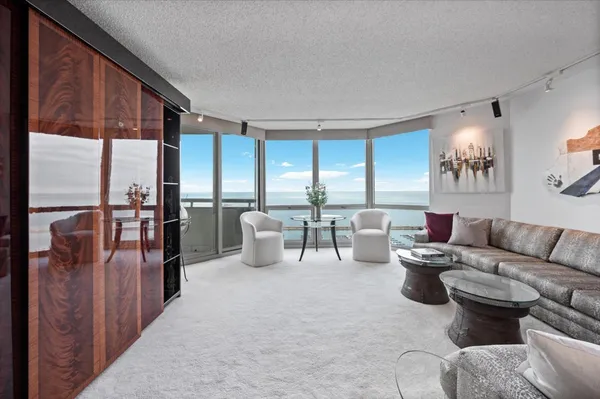 a living room with furniture and large windows