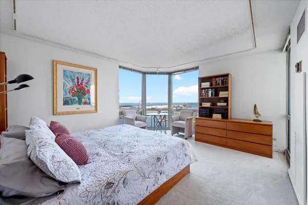 a bedroom with a bed furniture and a book shelf