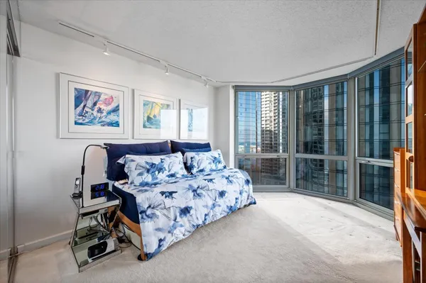a spacious bedroom with a bed and a large window