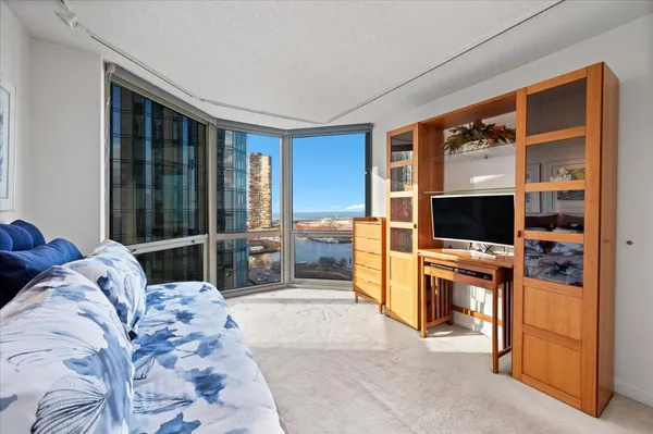a bedroom with furniture and a flat screen tv