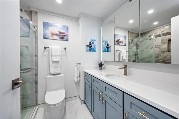 a bathroom with a toilet sink and mirror