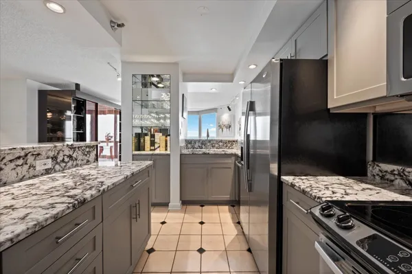a kitchen with a stove a refrigerator and a oven