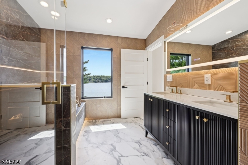 12 Rocky Point Road West Milford, NJ 07421 - Photo 30 of 50 a bathroom with a granite countertop sink a mirror and a shower