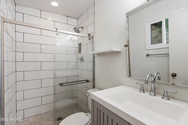 a bathroom with a sink toilet and shower