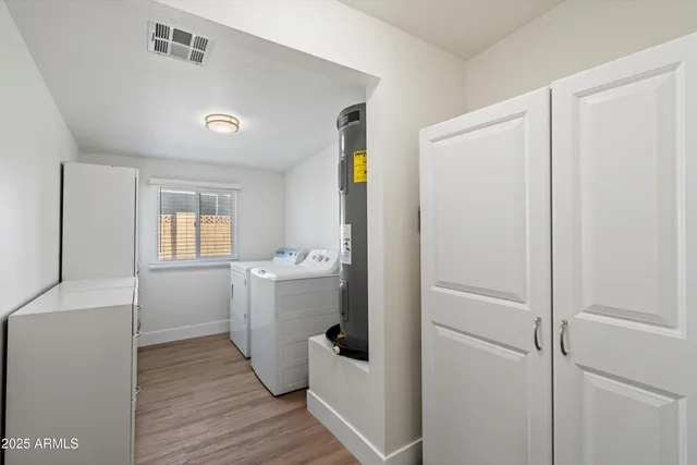 a room with a wooden floor and entryway