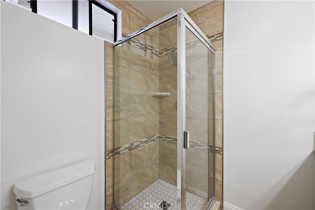 454 Seaward Road Corona del Mar, CA 92625 - Photo 12 of 33 a bathroom with a glass shower door
