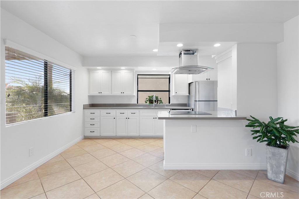 454 Seaward Road Corona del Mar, CA 92625 - Photo 4 of 33 a large kitchen with granite countertop a large white cabinets and a stove