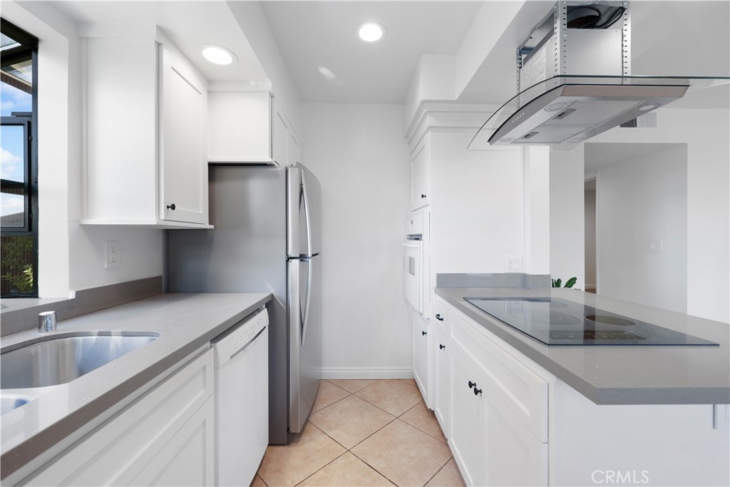 454 Seaward Road Corona del Mar, CA 92625 - Photo 5 of 33 a kitchen that has a sink and a refrigerator