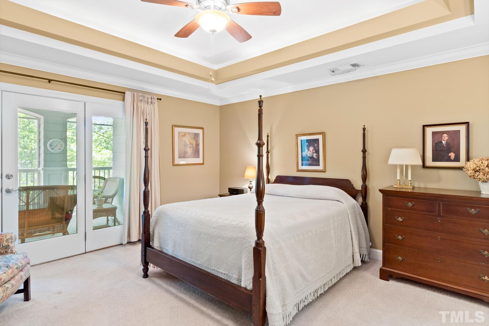 7500 Cadbury Court, Unit 101 Raleigh, NC 27615 - Photo 18 of 41 a bedroom with a large bed and a chandelier