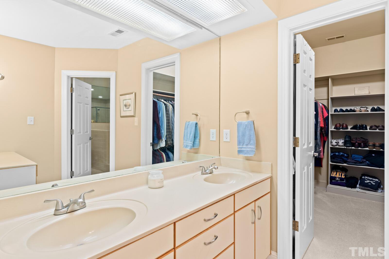 7500 Cadbury Court, Unit 101 Raleigh, NC 27615 - Photo 21 of 41 a bathroom with a sink and a mirror