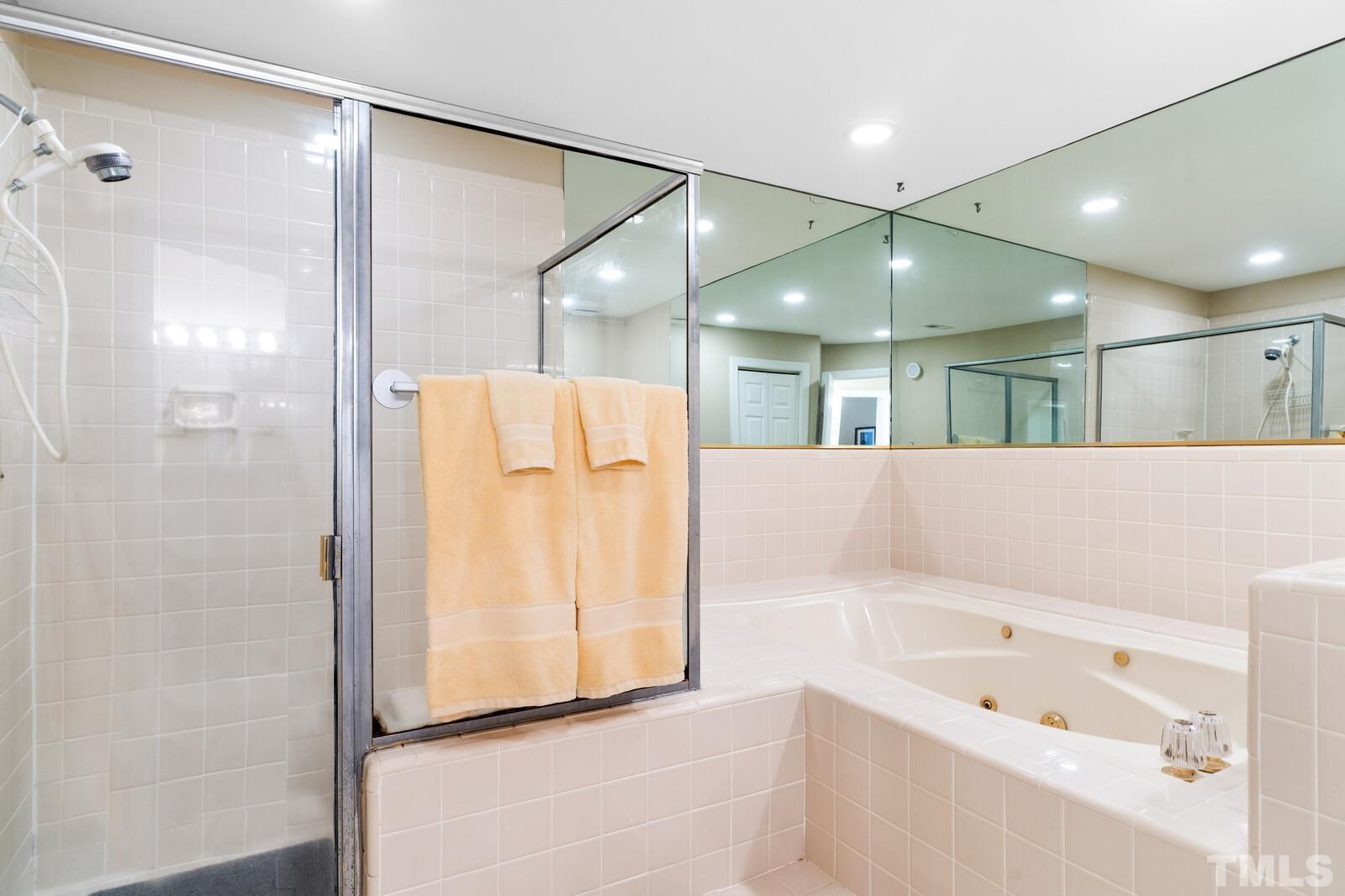 7500 Cadbury Court, Unit 101 Raleigh, NC 27615 - Photo 22 of 41 a bathroom with a bathtub and a shower