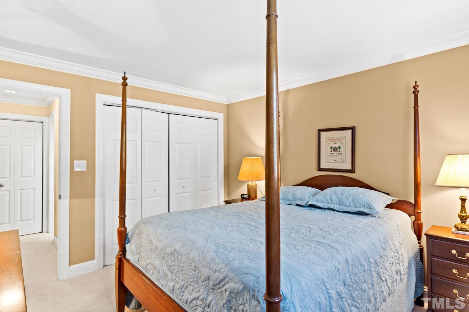 7500 Cadbury Court, Unit 101 Raleigh, NC 27615 - Photo 24 of 41 a bedroom with a large bed and a dresser