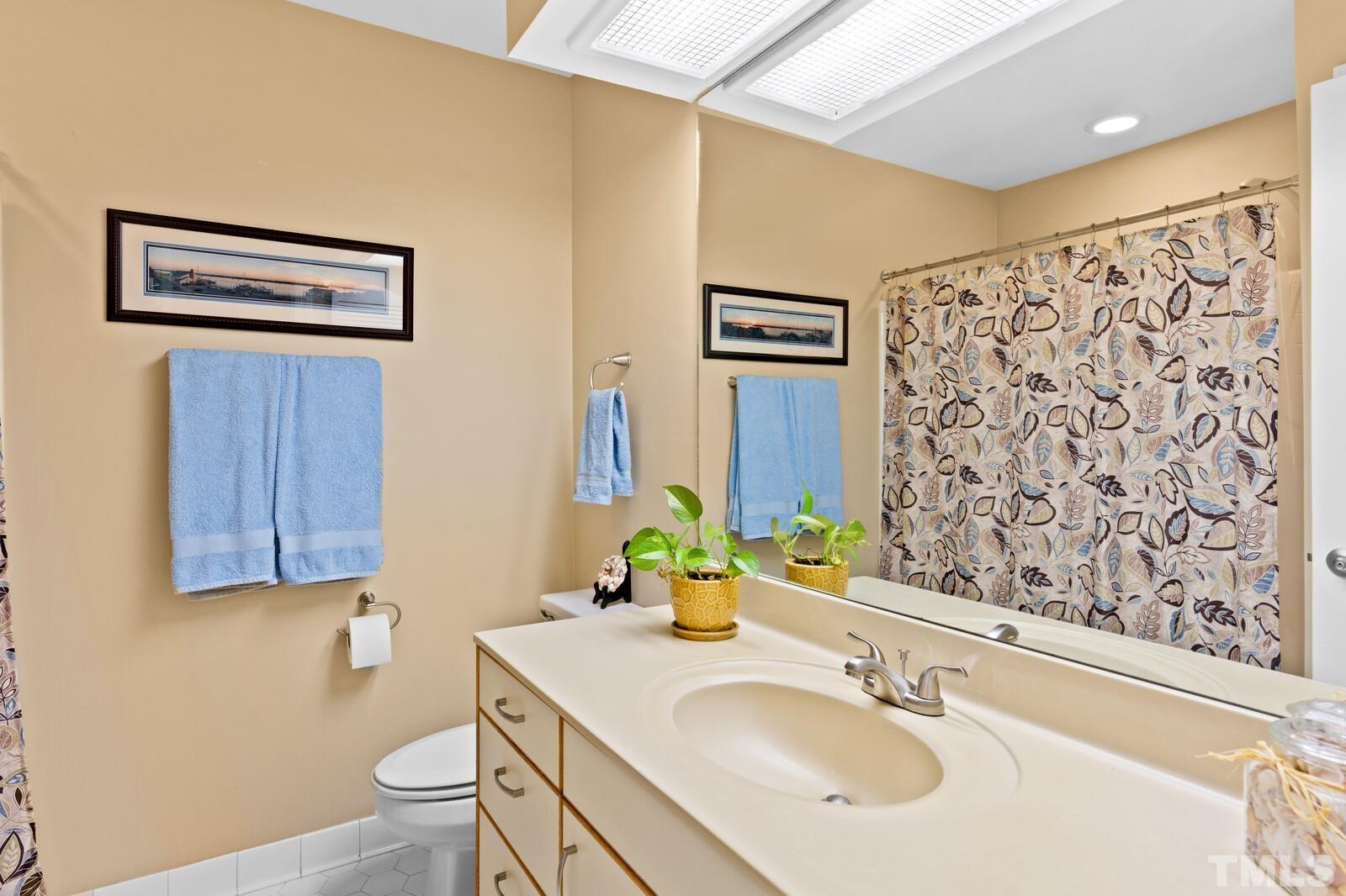 7500 Cadbury Court, Unit 101 Raleigh, NC 27615 - Photo 25 of 41 a bathroom with a sink toilet and shower